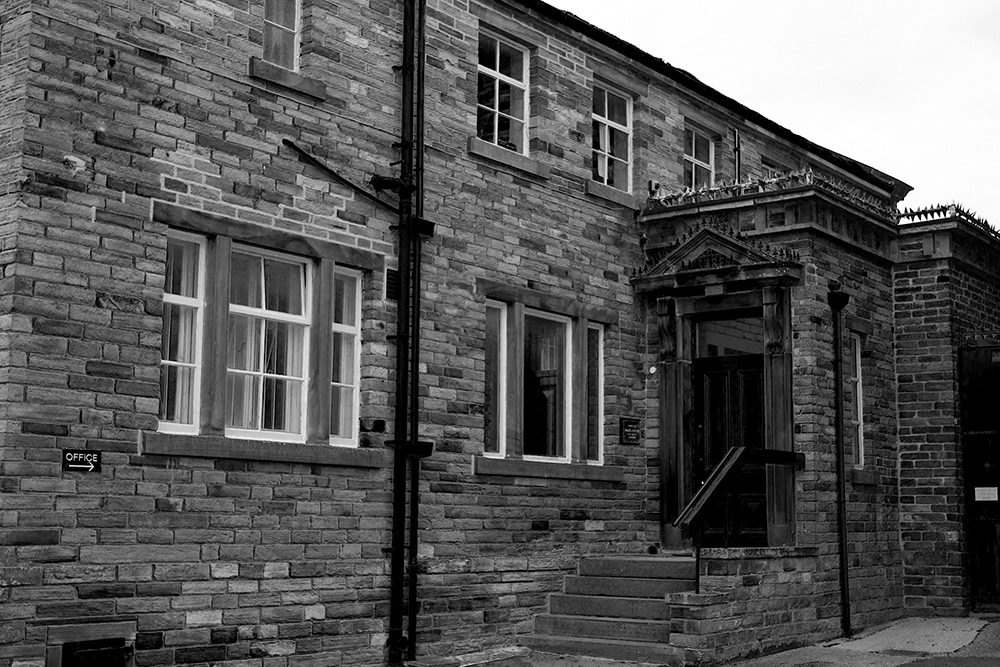 Outside of Whaleys Fabrics, black and white photo of the old building in Bradford